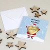 Karte mit Weihnachtsdruck und Lindt Schokoherz