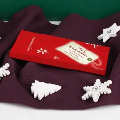 Süße Weihnachtsgrüße gedruckt auf einer Tafel Schokolade